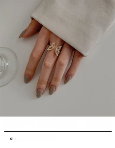 Detail of a golden butterfly open ring featuring shimmering micro-pave butterfly wings
