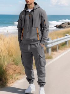 Detail of grey fleece hoodie with orange zipper and matching cargo pants for men