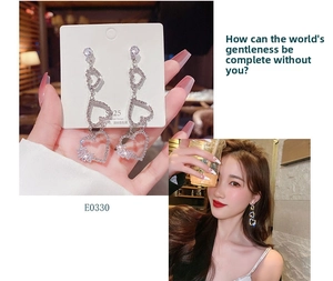 Detail of S925 sterling silver long tassel heart earrings with sparkling rhinestones