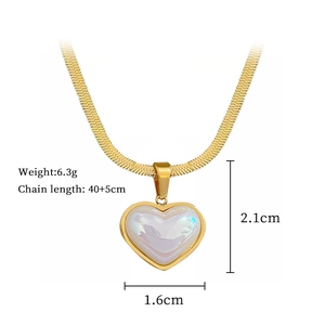 Macro shot of gold heart pendant necklace with measurements 2.1cm by 1.6cm dimensions