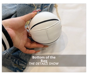 Detail view of the white basketball-shaped mini bag with gold chain and lychee texture