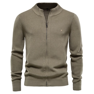 Detail of olive green knit cardigan featuring stand collar and smooth zipper closure