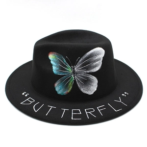 Black wool fedora hat featuring a colorful butterfly print and white text on the brim