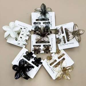 Detailed set of floral hair claws in various colors including white, amber and grey tones