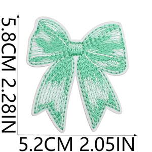 Detailed dimensions of a mint green bow embroidery patch with precise measurement marks