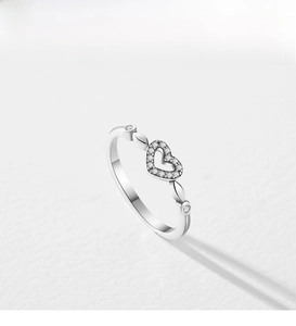 Detailed close-up of s925 silver heart ring with pavé zircons and olive leaf motifs