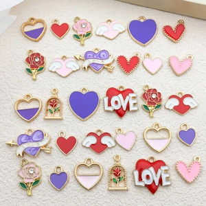 Flat lay of heart and rose enamel charms with gold plating for DIY jewelry