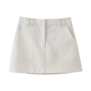 Detail of high-waisted A-line skirt with large side pockets and cotton linen texture
