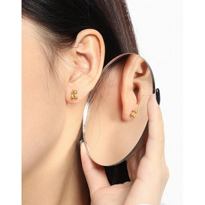 Minimalist golden bear stud earrings in S925 sterling silver shown in a creative mirror reflection