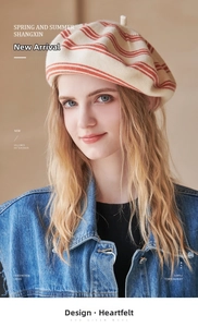 Detail of hand-woven wool beret showing beige and orange stripes and soft texture