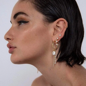 Boucles d'oreilles créoles dorées vintage avec perles et glands à chaînes sur un mannequin