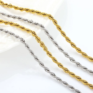 Detailed close-up of 18K gold and silver twist rope chains in stainless steel metal texture