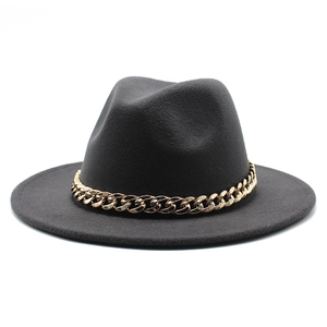 Close-up of black wool felt fedora featuring a bold decorative gold metal chain link