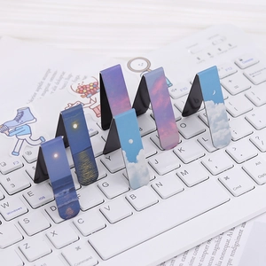 Magnetic bookmarks with aesthetic landscape clouds on a keyboard in a lifestyle scene