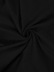 Close-up of black breathable linen fabric showing soft texture and natural grain pattern