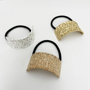 Three elegant elastic hair ties with textured gold and silver U-shaped metal buckles
