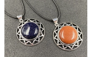 Detail of hexagram crystal pendants with blue goldstone and sunburst silver frames