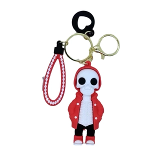 Cartoon skeleton keychain with red hoodie and woven lanyard on a white background