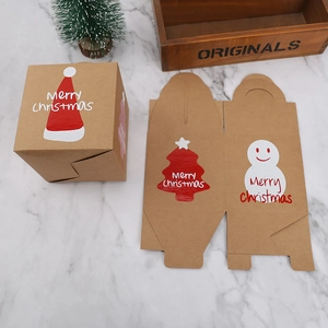 Macro shot of assembled Christmas kraft paper gift box with festive snowman and tree prints
