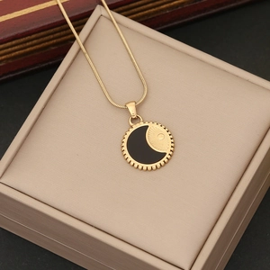 Golden stainless steel necklace featuring a round celestial sun and moon pendant design