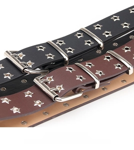 Detail of black and brown punk style belts with metal star-shaped eyelets and buckles