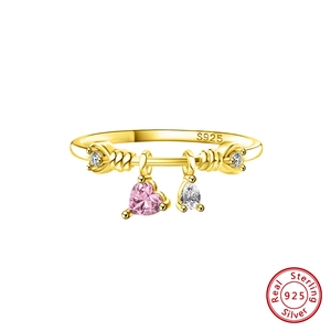 Detail view of gold-plated silver ring with pink heart and white drop zircon charms