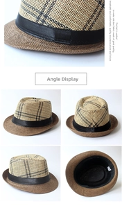 Detail view of woven straw fedora hat featuring a dark checkered crown and black ribbon