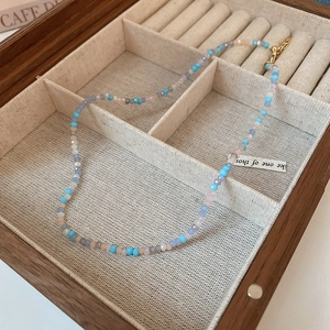 Detail of colorful faceted crystal beads and golden lobster clasp on a summer necklace