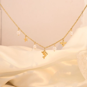 Detail of bohemian gold layered necklace featuring pearls and sea animal pendants