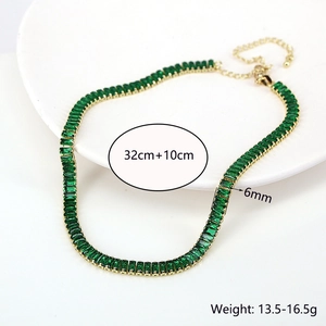 Macro detail of emerald green zircon rectangle cut necklace with gold metal adjustable chain