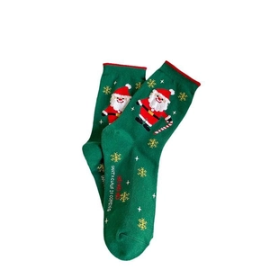 Green Christmas socks with Santa Claus pattern and Ho Ho Ho text in festive style