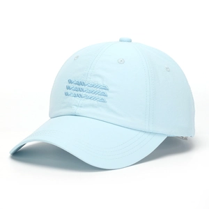Detail view of light blue baseball cap with three-row embroidered letters and curved brim