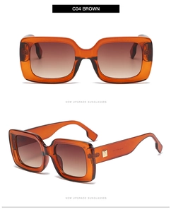 Detail of square amber frame sunglasses with brown gradient lenses and metal accents