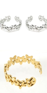 Macro detail of adjustable stainless steel rings featuring hollow star cutout patterns