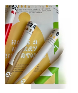 Detail of Christmas wrapping paper rolls with festive ginger man and bell patterns