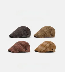 Detail view of striped retro flat caps in brown and tan with side metal buckle