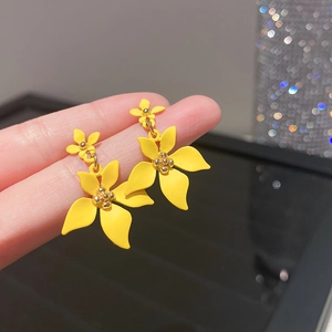 Detailed close-up of yellow floral tassel earrings with crystal flower petals and gold center