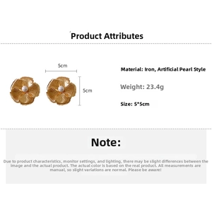 Detailed view of large gold metallic flower stud earrings with a pearl center and dimensions