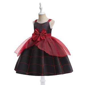 Detail of girls' Halloween dress featuring red tulle skirt and black spider web pattern