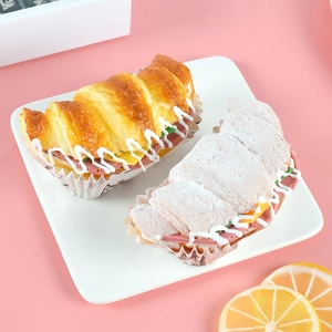 Realistic croissant food models with cream and vegetable salad fillings on a white plate