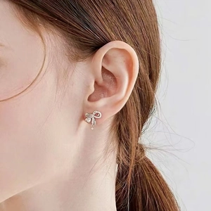 Minimalist silver bow earrings with sparkling zircons and delicate drop pendant