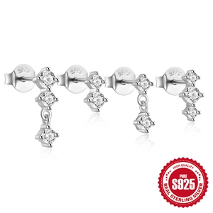 Set of four 925 sterling silver stud earrings with sparkling cubic zirconia on white background