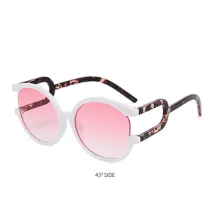 White cat eye sunglasses with pink gradient lenses and tortoiseshell cutout temples