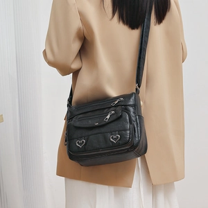 Sac bandoulière femme en similicuir noir avec multiples poches zippées et sangle