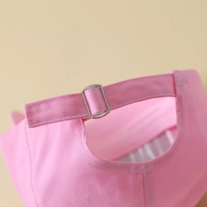 Detail of adjustable metal buckle on pink cotton baseball cap with dragonfly crystals