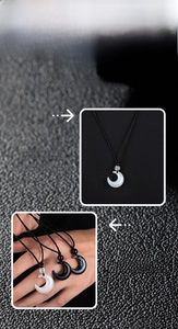 Detail view of crescent moon pendant necklace with woven cord and glossy stone finish