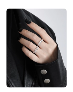 Detail shot of silver S925 rings with lava texture on a model wearing black leather