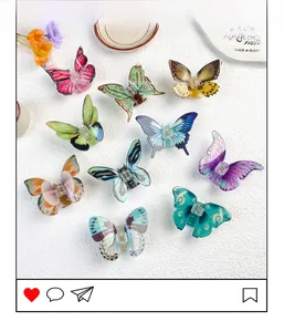 Macro view of 10 colorful butterfly hair claws with gradient acrylic wing textures