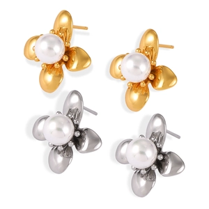 Elegant gold and silver floral stud earrings with white pearls on a clean white background