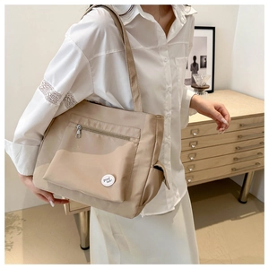 Khaki large capacity nylon tote bag shown on a model for casual daily commuting
